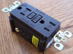 Black tamper resistant electrical socket image