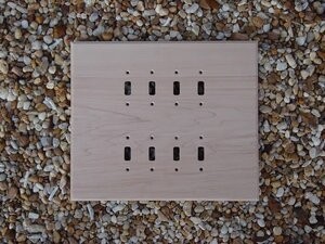Poplar switchplate for eight-switch configuration on a pebble background